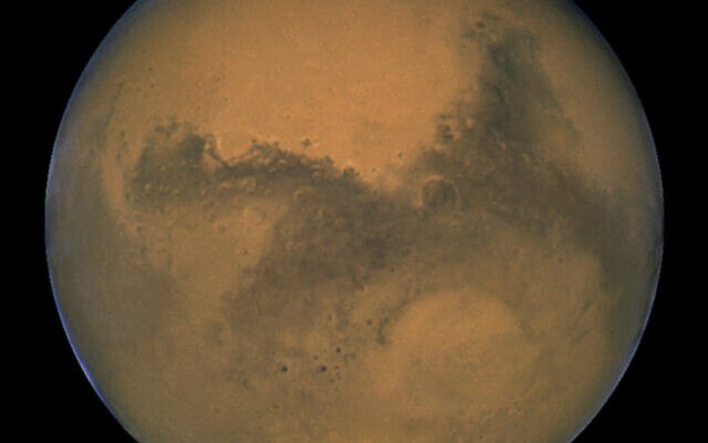 This Aug. 26, 2003 image made available by NASA shows Mars as it lines up with the Sun and the Earth. Photographed by the Hubble Space Telescope, it was about 55.8 million kilometers (34.6 million miles) from Earth. (J. Bell/NASA via AP) This Aug. 26, 2003 image made available by NASA shows Mars as it lines up with the Sun and the Earth. Photographed by the Hubble Space Telescope, it was about 55.8 million kilometers (34.6 million miles) from Earth. (J. Bell/NASA via AP)