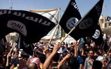 Demonstrators chant pro-Islamic State group slogans as they wave the group's flags in front of the provincial government headquarters in Mosul, Iraq, June 16, 2014. (AP Photo, File)