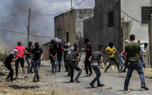 Palestinians clash with Israeli soldiers during a protest against Israel's plan to annex parts of the West Bank, in the village of Kfar Qaddum, near the West Bank city of Nablus on June 19, 2020. (Nasser Ishtayeh/Flash90) Palestinians clash with Israeli soldiers during a protest against Israel's plan to annex parts of the West Bank, in the village of Kfar Qaddum, near the West Bank city of Nablus on June 19, 2020. (Nasser Ishtayeh/Flash90)