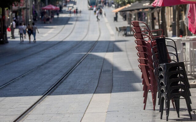 Stacked chairs outside a restaurant on Jaffa Street in Jerusalem on July 17, 2020. (Yonatan Sindel/Flash90) Stacked chairs outside a restaurant on Jaffa Street in Jerusalem on July 17, 2020. (Yonatan Sindel/Flash90)