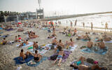 Israelis enjoy the hot weather at the beach in Tel Aviv, September 5, 2020. (Miriam Alster/FLASH90)