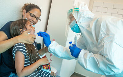 Clalit Health care workers take test samples of Israelis to check if they have been infected with the coronavirus, in a testing center in Modiin Illit, on September 7, 2020. (Yossi Aloni/FLASH90)