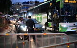 Police seen at the entrance to the ultra-Orthodox city of Bnei Brak as Israel enforces a night curfew, applied to some 40 cities all over country which have been badly infected with the coronavirus, September 8, 2020. (Tomer Neuberg/FLASH90)