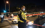 Police seen at the entrance to the neighborhood of Ramot in Jerusalem as Israel began enforcing a nightly curfew, September 8, 2020 (Yonatan Sindel/Flash90)