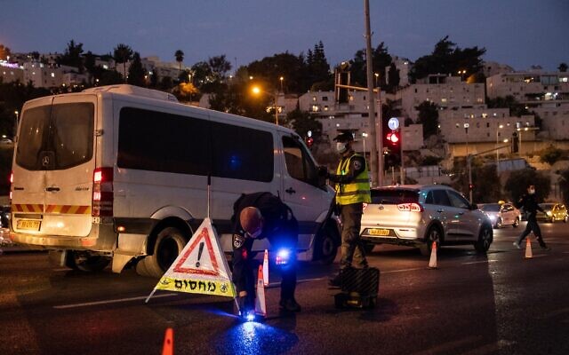 Israeli police seen at the entrance to the neighborhood of Ramot in Jerusalem, as Israel enforces a night curfew, applied to some 40 cities all over Israel which have been badly affected by the coronavirus, September 9, 2020. (Yonatan Sindel/ Flash90) Israeli police seen at the entrance to the neighborhood of Ramot in Jerusalem, as Israel enforces a night curfew, applied to some 40 cities all over Israel which have been badly affected by the coronavirus, September 9, 2020. (Yonatan Sindel/ Flash90)