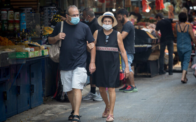 People wear protective face masks in Tel Aviv, September 10, 2020 (Miriam Alster/FLASH90) People wear protective face masks in Tel Aviv, September 10, 2020 (Miriam Alster/FLASH90)