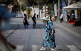 People walk with face masks on Jaffa street in Jerusalem on September 10, 2020. (Yonatan Sindel/Flash90)