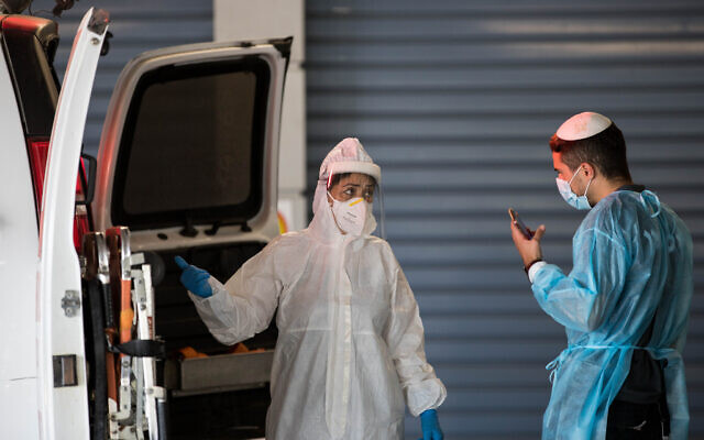 Magen David Adom workers wearing protective clothing outside the coronavirus unit at Shaare Zedek hospital in Jerusalem on September 13, 2020. (Nati Shohat/Flash90) Magen David Adom workers wearing protective clothing outside the coronavirus unit at Shaare Zedek hospital in Jerusalem on September 13, 2020. (Nati Shohat/Flash90)