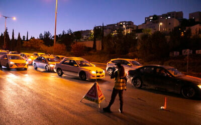 Police seen at the entrance to the Ramot neighborhood of Jerusalem as Israel enforces a night curfew, applied to some 40 cities and areas all over Israel which have been badly affected by the coronavirus, September 13, 2020. (Yonatan Sindel/Flash90) Police seen at the entrance to the Ramot neighborhood of Jerusalem as Israel enforces a night curfew, applied to some 40 cities and areas all over Israel which have been badly affected by the coronavirus, September 13, 2020. (Yonatan Sindel/Flash90)