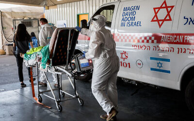 Magen David Adom medical workers wearing protective clothing outside the coronavirus unit at Shaare Zedek hospital in Jerusalem on September 14, 2020. (Nati Shohat/Flash90)