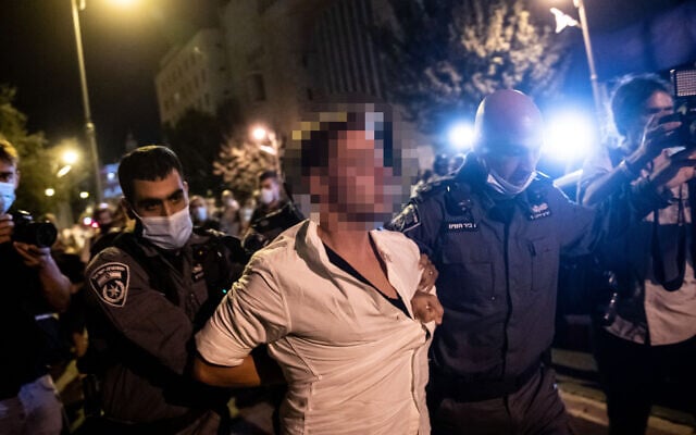 Police arrest a man suspected of speeding in his car toward protesters during a rally against Prime Minister Benjamin Netanyahu outside his official residence in Jerusalem, September 20, 2020. (Yonatan Sindel/Flash90) Police arrest a man suspected of speeding in his car toward protesters during a rally against Prime Minister Benjamin Netanyahu outside his official residence in Jerusalem, September 20, 2020. (Yonatan Sindel/Flash90)