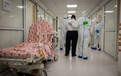 Hospital team members wearing protective clothes as they work at the Coronavirus ward of Shaare Zedek hospital in Jerusalem on September 23, 2020 (Nati Shohat/Flash90)