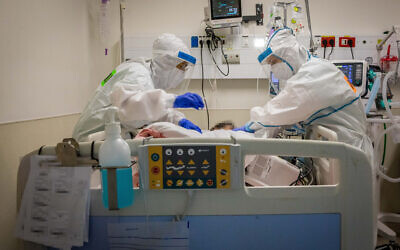 Healthcare workers wearing protective clothes as they work at the coronavirus ward of Shaare Zedek hospital in Jerusalem on September 23, 2020. (Nati Shohat/Flash90)