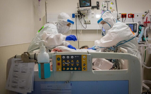 Healthcare workers wearing protective clothes as they work at the coronavirus ward of Shaare Zedek hospital in Jerusalem on September 23, 2020. (Nati Shohat/Flash90) Healthcare workers wearing protective clothes as they work at the coronavirus ward of Shaare Zedek hospital in Jerusalem on September 23, 2020. (Nati Shohat/Flash90)