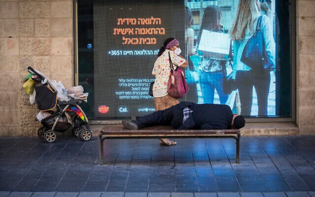 People walk next to closed shops on Jaffa Street in downtown Jerusalem, on September 23, 2020, during a nationwide lockdown to prevent the spread of COVID-19. (Olivier Fitoussi/Flash90) People walk next to closed shops on Jaffa Street in downtown Jerusalem, on September 23, 2020, during a nationwide lockdown to prevent the spread of COVID-19. (Olivier Fitoussi/Flash90)