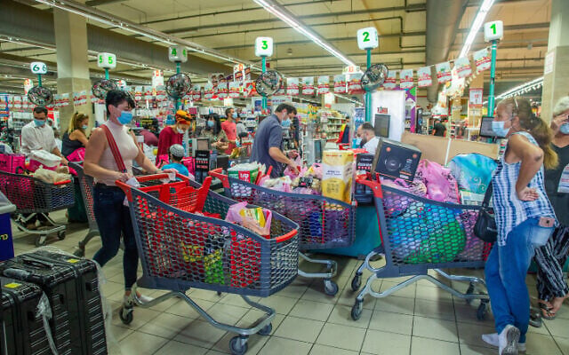 People shop for groceries at the Rami Levy supermarket in Modi'in, on September 24, 2020. (Yossi Aloni/Flash90) People shop for groceries at the Rami Levy supermarket in Modi'in, on September 24, 2020. (Yossi Aloni/Flash90)