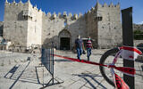 People walk outside the Damascus Gate to the Old City of Jerusalem on September 25, 2020, amid a nationwide coronavirus lockdown. (Olivier Fitoussi/Flash90)