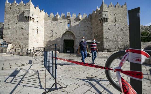 People walk outside the Damascus Gate to the Old City of Jerusalem on September 25, 2020, amid a nationwide coronavirus lockdown. (Olivier Fitoussi/Flash90) People walk outside the Damascus Gate to the Old City of Jerusalem on September 25, 2020, amid a nationwide coronavirus lockdown. (Olivier Fitoussi/Flash90)