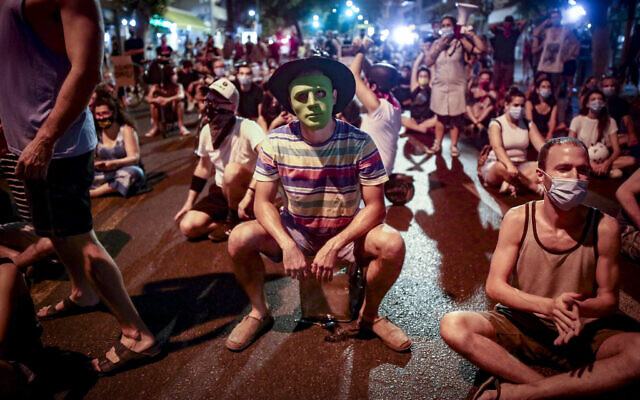 Protesters block a road as they demonstrate against Prime Minister Benjamin Netanyahu in Tel Aviv on September 30, 2020. (Miriam Alster/Flash90) Protesters block a road as they demonstrate against Prime Minister Benjamin Netanyahu in Tel Aviv on September 30, 2020. (Miriam Alster/Flash90)