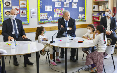 Prime Minister Benjamin Netanyahu (C) and Education Minister Yoav Gallant (L) visit Israeli kids on their first day of school in the Mevo Horon settlement on September 1, 2020. (Marc Israel Sellem/POOL)