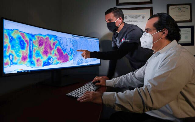 Pathologists at CorePlus in Puerto Rico reviewing a cancer heatmap generated using AI technology developed by Israel's Ibex Medical Analytics. (Courtesy) Pathologists at CorePlus in Puerto Rico reviewing a cancer heatmap generated using AI technology developed by Israel's Ibex Medical Analytics. (Courtesy)