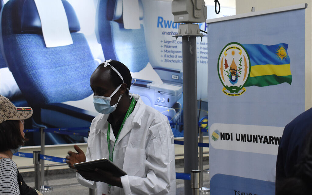 A Rwandan Health Ministry worker screens arriving passengers for COVID-19 infections at Kigali International Airport, February 2020. (Larry Luxner/Times of Israel)