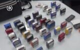 Screen capture from video of stamps seized by police during an investigation into a large-scale tax offenses and money laundering case. Image blurred to protect the identity of victims of the scam. (Israel Police)