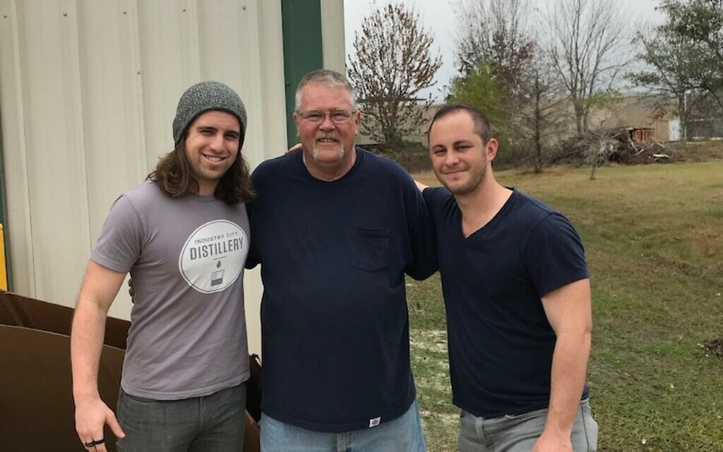 Christopher Haugh, left, and Jordan Blashek, right, pose with Pete, center, a trucker who gave them a ride and some perspective. (Courtesy)