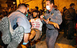 Police remove demonstrators who were blocking a road during a protest against Prime Minister Benjamin Netanyahu outside his official residence in Jerusalem, September 20, 2020. (Olivier Fitoussi/Flash90)