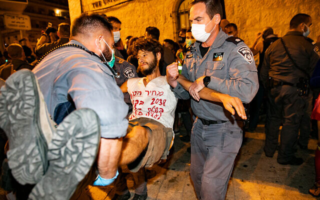 Police remove demonstrators who were blocking a road during a protest against Prime Minister Benjamin Netanyahu outside his official residence in Jerusalem, September 20, 2020. (Olivier Fitoussi/Flash90) Police remove demonstrators who were blocking a road during a protest against Prime Minister Benjamin Netanyahu outside his official residence in Jerusalem, September 20, 2020. (Olivier Fitoussi/Flash90)