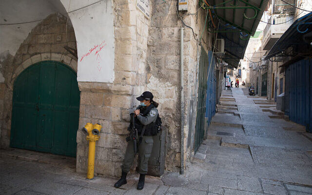 A border police officer on patrol in Jerusalem's Old City during a nationwide coronavirus lockdown, September 27, 2020. (Nati Shohat/Flash90) A border police officer on patrol in Jerusalem's Old City during a nationwide coronavirus lockdown, September 27, 2020. (Nati Shohat/Flash90)