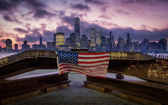 A US flag hanging from a steel girder, damaged in the Sept. 11, 2001 attacks on the World Trade Center, blows in the breeze at a memorial in Jersey City, N.J., Sept. 11, 2019. (AP Photo/J. David Ake) A US flag hanging from a steel girder, damaged in the Sept. 11, 2001 attacks on the World Trade Center, blows in the breeze at a memorial in Jersey City, N.J., Sept. 11, 2019. (AP Photo/J. David Ake)