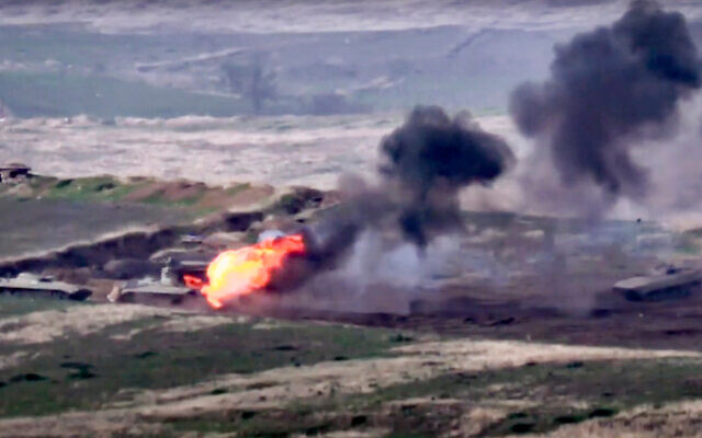 In this image taken from a footage released by Armenian Defense Ministry, Armenian forces destroy an Azerbaijani military vehicle at the contact line of the self-proclaimed Republic of Nagorno-Karabakh, Azerbaijan, September 27, 2020. (Armenian Defense Ministry via AP) In this image taken from a footage released by Armenian Defense Ministry, Armenian forces destroy an Azerbaijani military vehicle at the contact line of the self-proclaimed Republic of Nagorno-Karabakh, Azerbaijan, September 27, 2020. (Armenian Defense Ministry via AP)