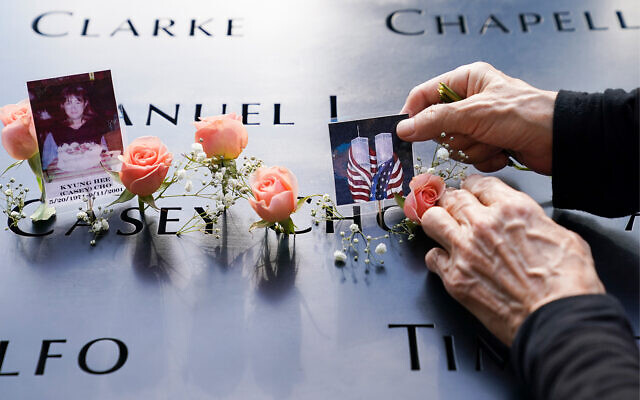 Mourners place flowers and pictures at the National September 11 Memorial and Museum in New York, September 11, 2020. (AP Photo/John Minchillo) Mourners place flowers and pictures at the National September 11 Memorial and Museum in New York, September 11, 2020. (AP Photo/John Minchillo)