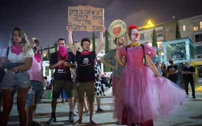 Anti-government protesters in Tel Aviv ahead of the start of Israel's second coronavirus lockdown, September 17, 2020. The sign reads: "When injustice becomes law, rebellion becomes a must."  (Miriam Alster/Flash90)