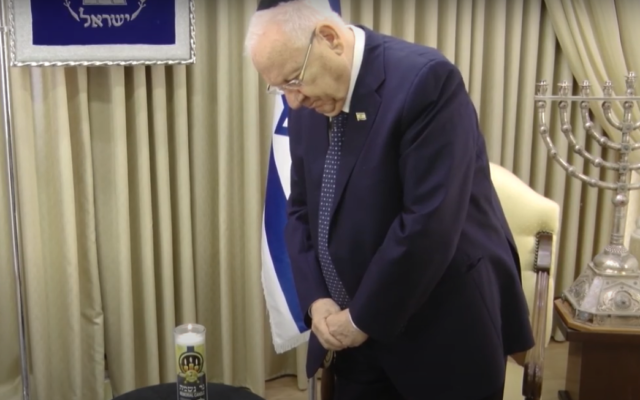 President Reuven Rivlin lights a memorial candle for coronavirus victims during a video message ahead of Yom Kippur, September 27, 2020. (Screen capture: YouTube) President Reuven Rivlin lights a memorial candle for coronavirus victims during a video message ahead of Yom Kippur, September 27, 2020. (Screen capture: YouTube)