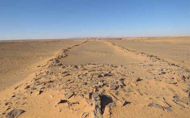 A massive, ancient stone structure in Saudi Arabia, with platforms at both ends and connecting walls in between. Two barely visible researchers standing at the far end provide a sense of scale. (courtesy/ Huw Groucutt/ The Holocene) A massive, ancient stone structure in Saudi Arabia, with platforms at both ends and connecting walls in between. Two barely visible researchers standing at the far end provide a sense of scale. (courtesy/ Huw Groucutt/ The Holocene)