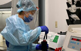 Illustrative image: A lab technician processes blood samples. (AP/Taimy Alvarez)