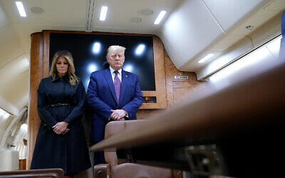 US President Donald Trump and first lady Melania Trump pause for a moment of silence on Air Force One as he arrives at the airport in Johnstown, Pennsylvania, on his way to speak at the Flight 93 National Memorial in Shanksville, Pennsylvania, September 11, 2020. (AP Photo/Alex Brandon)
