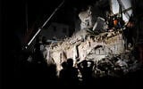 Lebanese and Chilean rescuers search a collapsed building in Beirut, Sept. 4, 2020. (AP Photo/Hussein Malla)