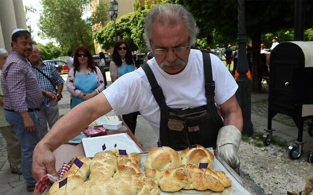 Hungarian Jews bake challah in front of the Obuda Synagogue in Budapest in 2018. (Zsolt Demecs/Courtesy of EMIH via JTA) Hungarian Jews bake challah in front of the Obuda Synagogue in Budapest in 2018. (Zsolt Demecs/Courtesy of EMIH via JTA)