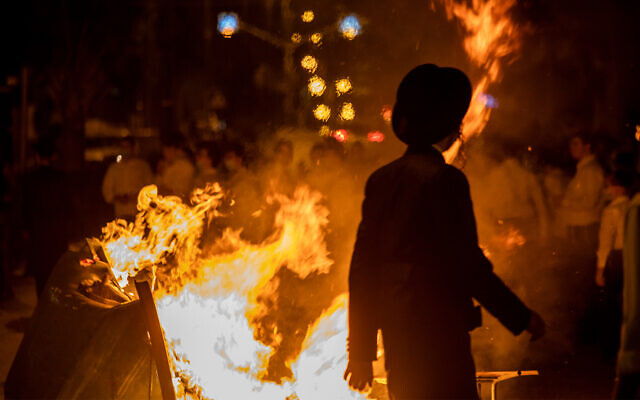 A fire burns as ultra-Orthodox Jews protest against coronavirus restrictions in Bnei Brak, September 20, 2020. (AP Photo/Ariel Schalit) A fire burns as ultra-Orthodox Jews protest against coronavirus restrictions in Bnei Brak, September 20, 2020. (AP Photo/Ariel Schalit)