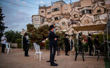 Men hold prayers outdoors in Jerusalem on September 9, 2020. (Yonatan Sindel/Flash90)