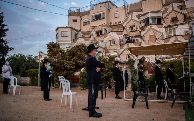 Men hold prayers outdoors in Jerusalem on September 9, 2020. (Yonatan Sindel/Flash90) Men hold prayers outdoors in Jerusalem on September 9, 2020. (Yonatan Sindel/Flash90)
