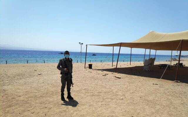 A police officer patrols a beach in Eilat as a Jordanian national is suspected of crossing into Israel from Jordan on September 2, 2020. (Israel Police) A police officer patrols a beach in Eilat as a Jordanian national is suspected of crossing into Israel from Jordan on September 2, 2020. (Israel Police)