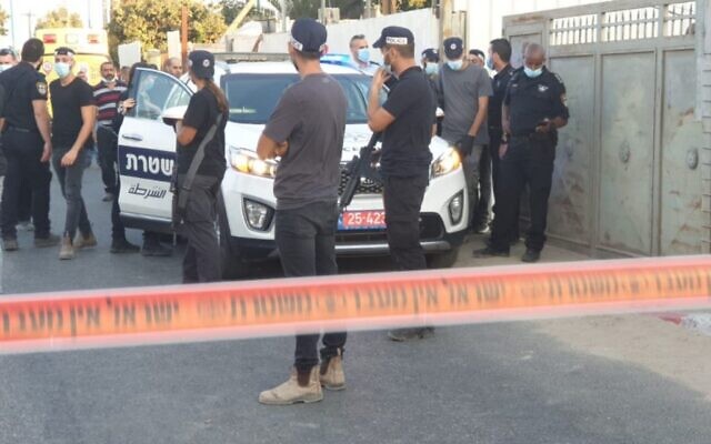 Police investigators at the scene of a deadly shooting attack in the central Israeli city of Lod, on September 13, 2020. (courtesy, Israel Police/via Channel 12) Police investigators at the scene of a deadly shooting attack in the central Israeli city of Lod, on September 13, 2020. (courtesy, Israel Police/via Channel 12)