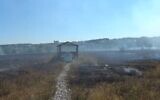 Grass smolders after a fire at a Jewish cemetery in Uman, Ukraine, August 31, 2020 (Screen grab)