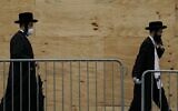 Illustrative: Orthodox Jewish men walk through a Brooklyn neighborhood on September 29, 2020 in New York. (Timothy A. Clary/AFP)