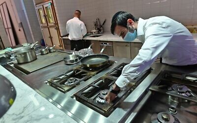 Illustrative; Rabbi Yaakov Eisenstein (R) supervises the preparation of food Elli's Kosher Kitchen, in Dubai, on October 5, 2020 (GIUSEPPE CACACE / AFP)