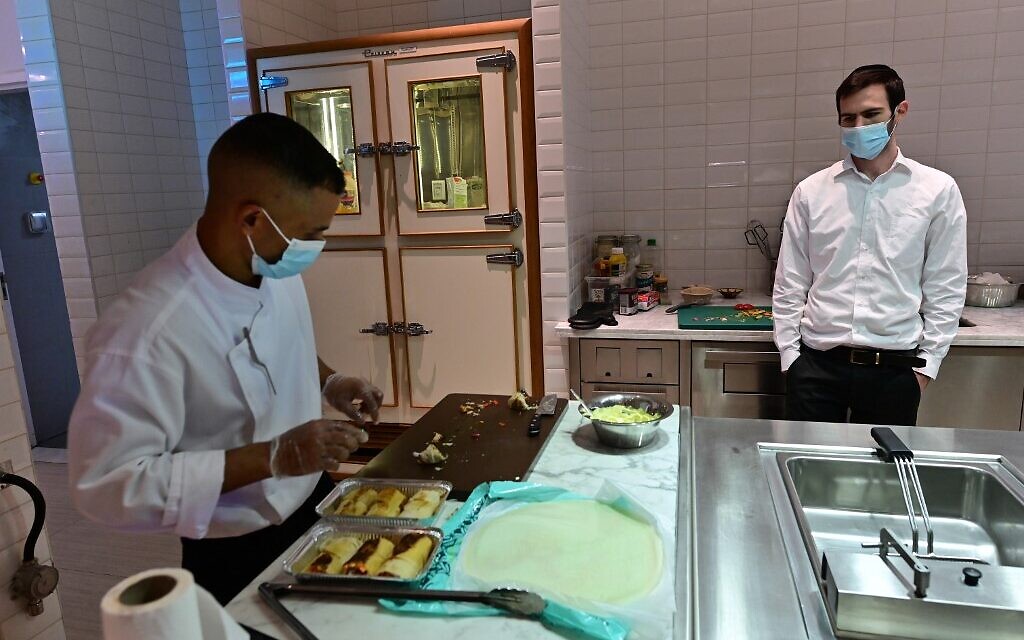Rabbi Yaakov Eisenstein (R) supervises the preparation of food Elli's Kosher Kitchen, in Dubai, on October 5, 2020 (GIUSEPPE CACACE / AFP)
